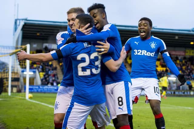 Midfielder Jason Holt (23) celebrates his 22nd-minute opening goal with his Rangers team-mates. Picture: SNS
