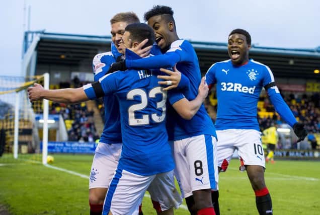 Midfielder Jason Holt (23) celebrates his 22nd-minute opening goal with his Rangers team-mates. Picture: SNS