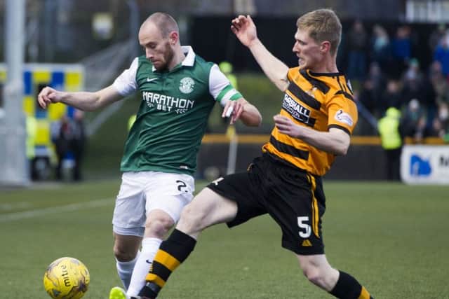 Hibs captain David Gray is closed down by Colin Hamilton during yesterdays game at the Indodrill Stadium. Hibs 1-0 victory put them level on points with league leaders Rangers. Picture: SNS