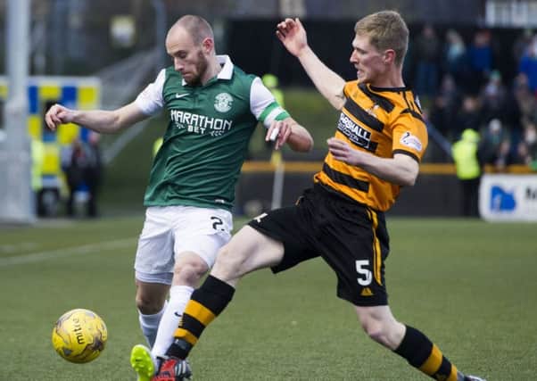 Hibs captain David Gray is closed down by Colin Hamilton during yesterdays game at the Indodrill Stadium. Hibs 1-0 victory put them level on points with league leaders Rangers. Picture: SNS