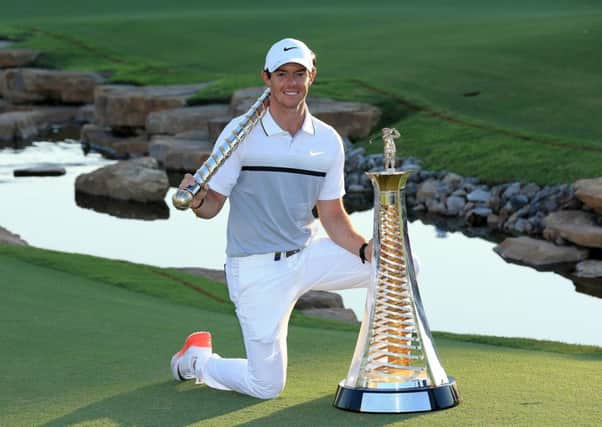 Rory McIlroy poses with the DP World Tour Championship and Race to Dubai trophies after his one-shot win at Jumeirah Golf Estates. Picture: Getty