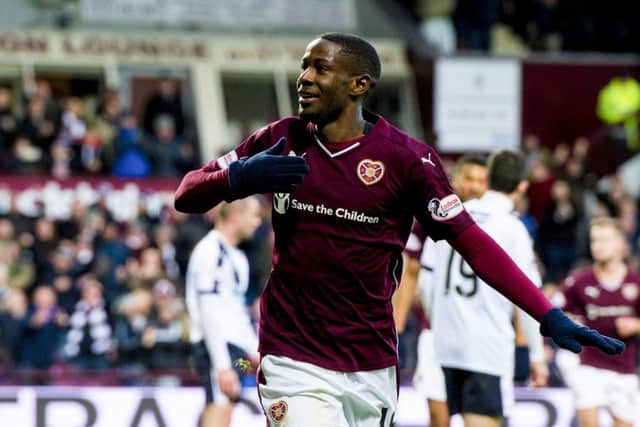 Arnaud Djoum celebrates after heading past Dundee goalkeeper Scott Bain to open the scoring for Hearts. Picture: SNS