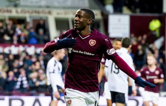 Arnaud Djoum celebrates after heading past Dundee goalkeeper Scott Bain to open the scoring for Hearts. Picture: SNS