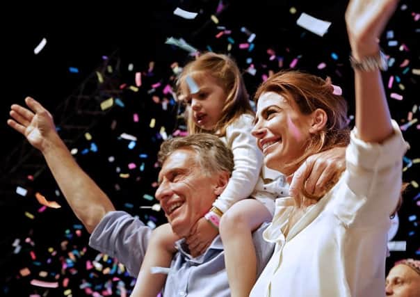 Mauricio Macri  celebrates with his wife Juliana Awada and his daughter Antonia at the Cambiemos (Lets Change) party headquarters in Buenos Aires. Picture: Getty