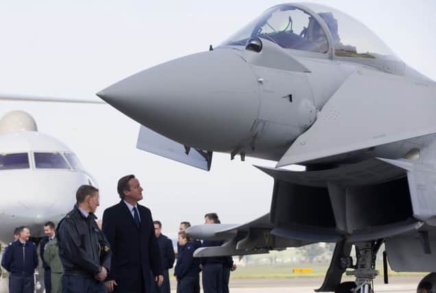 Prime Minister David Cameron looks at an RAF Typhoon fighter jet during his visit to Royal Air Force station Northolt. Picture: Getty