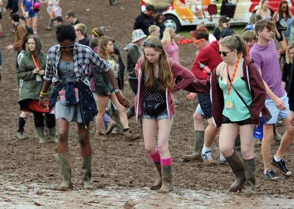 T in the Park attendees make their way through the mud at Strathallan earlier this year. Picture: Lisa Ferguson