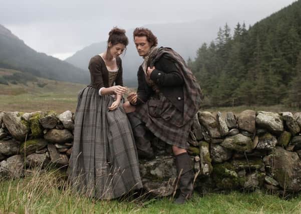 Caitriona Balfe and Sam Heughan playing Claire Randall and Jamie Fraser in Outlander.