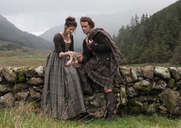 Caitriona Balfe and Sam Heughan playing Claire Randall and Jamie Fraser in Outlander.