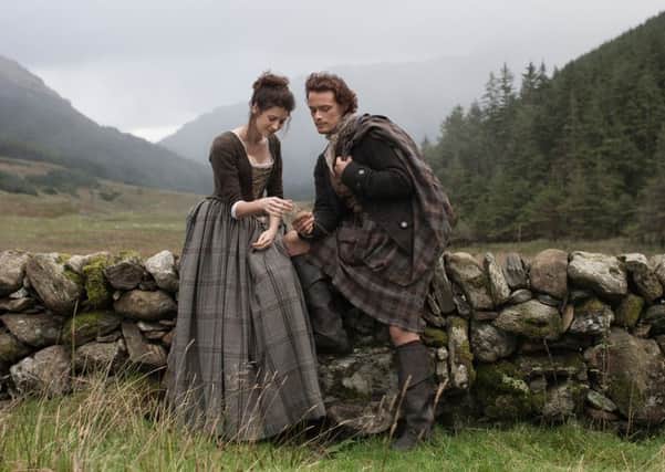 Caitriona Balfe and Sam Heughan playing Claire Randall and Jamie Fraser in the TV series Outlanders