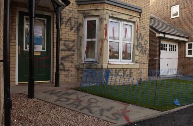 Racist graffiti daubed on a new-build property in Edinburgh after a Pakistani family moved in. Picture: Toby Williams