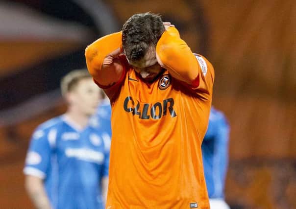 Dundee Utd debutant Gavin Gunning cuts a dejected figure at full time. Picture: SNS