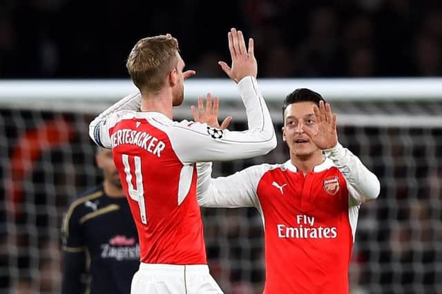 Per Mertesacker congratulates Arsenal team-mate Mesut Ozil for opening the scoring last night. Picture: Getty