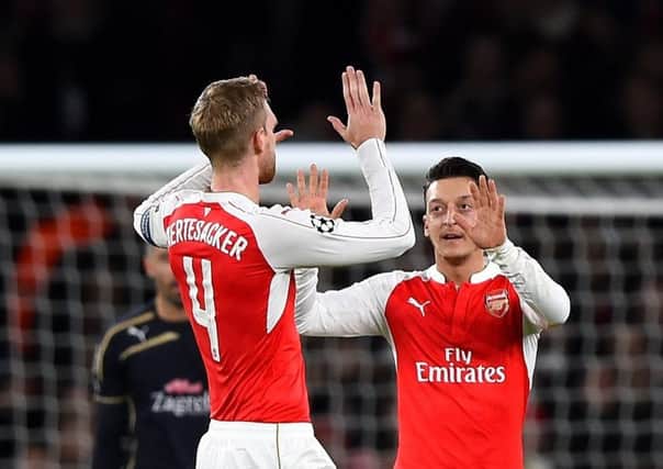 Per Mertesacker congratulates Arsenal team-mate Mesut Ozil for opening the scoring last night. Picture: Getty