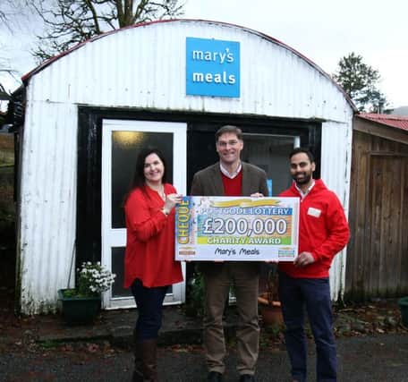 Clara Govier, Head of Charities and Communications at Peoples Postcode Lottery; Magnus MacFarlane-Barrow, founder and CEO of Marys Meals; and Sanjay Singh, Trusts Manager at Peoples Postcode Lottery at the shed, which acts as Magnus office and the charitys headquarters in Dalmally, Argyll