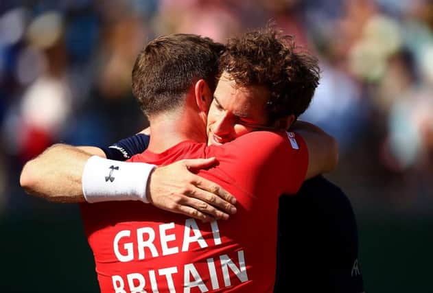Smith celebrating with Andy Murray after GBs  last-eight victory over France. Picture: Getty