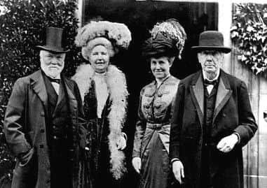 Andrew Carnegie stands next to his wife Louise and their guests. ca. 1900s