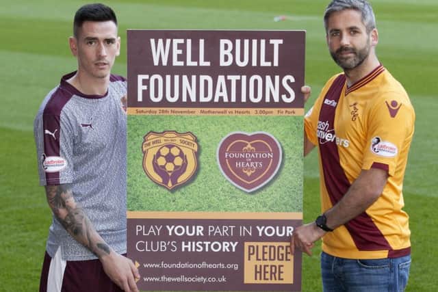 Jamie Walker, left, joins Motherwell skipper Keith Lasley as The Foundation of Hearts and the Well Society teamed up at Fir Park. Picture: SNS