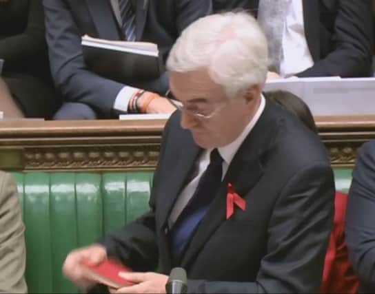 Shadow chancellor John McDonnell offers a copy of Chairman Mao's Little Red Book to George Osborne. Picture: PA