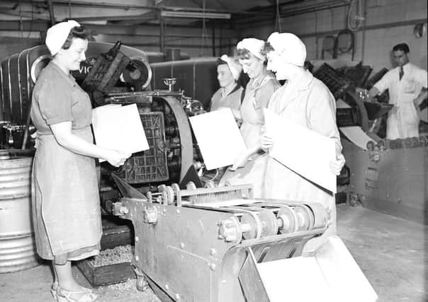 Thomas Tunnock Ltd biscuit factory Uddingston -  Sheet of wafer biscuit comes off machine.