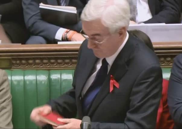John McDonnell makes his gaffe with the Mao's Little Red Book. Picture: PA