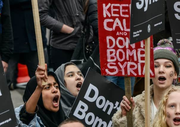 Protesters outside Downing Street on Saturday. Opinion polls suggest 48 per cent of people back air raids on Isis. Picture: Getty Images