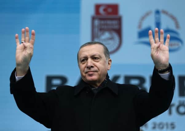 President Recep Tayyip Erdogan addresses a rally as Russia announced that it will suspend visa-free travel with Turkey. Picture: AP