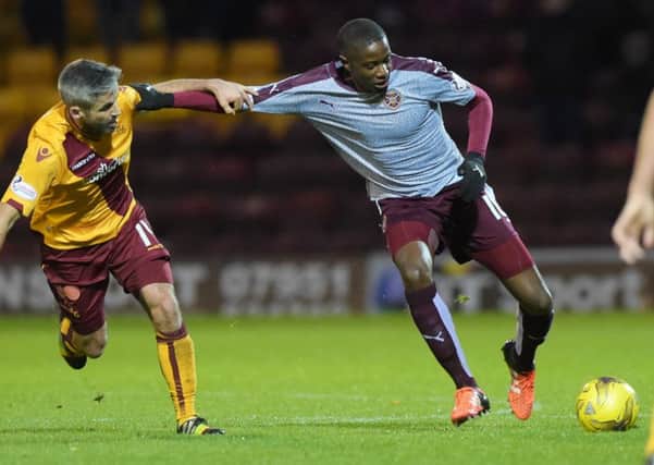 Motherwell's Keith Lasley (left) battles with Arnaud Djoum. Picture: SNS