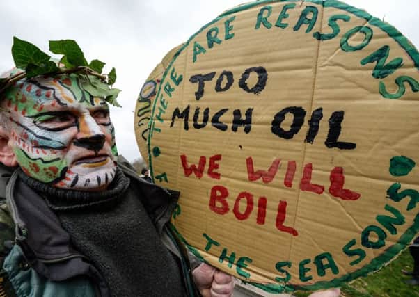 A protester dressed as the green man prepares to march during the London Climate March. Picture: Getty Images
