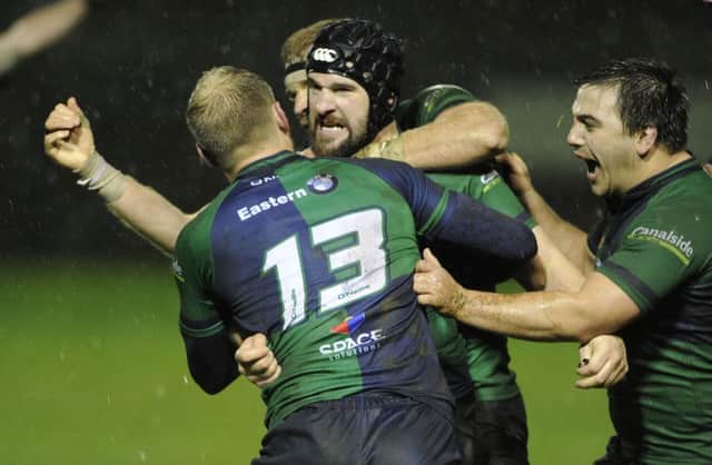 Boroughmuir players mob David Reekie after he kicks the winning conversion in injury time. Picture: Neil Hanna