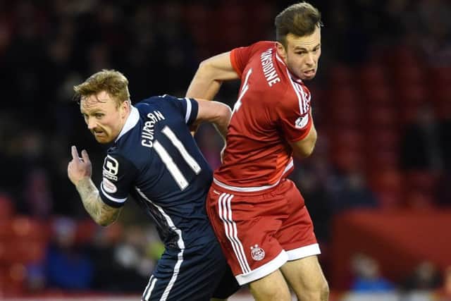 Ross County goalscorer Craig Curran tussles with Dons defender Andrew Considine at Pittodrie. Picture: SNS Group