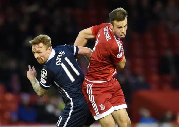 Ross County goalscorer Craig Curran tussles with Dons defender Andrew Considine at Pittodrie. Picture: SNS Group
