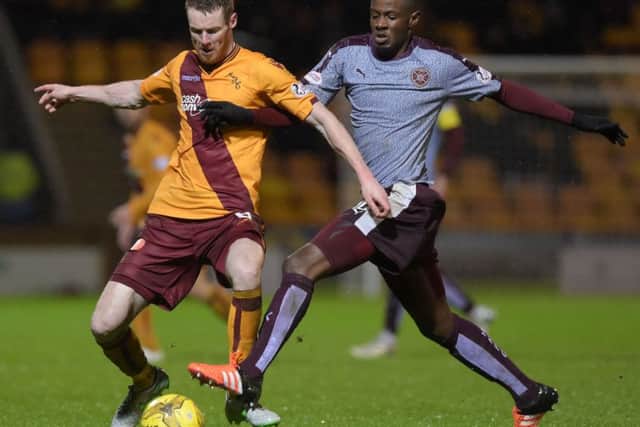 Hearts midfielder Arnaud Djoum, right, tussles with Stephen Pearson. Picture: SNS Group