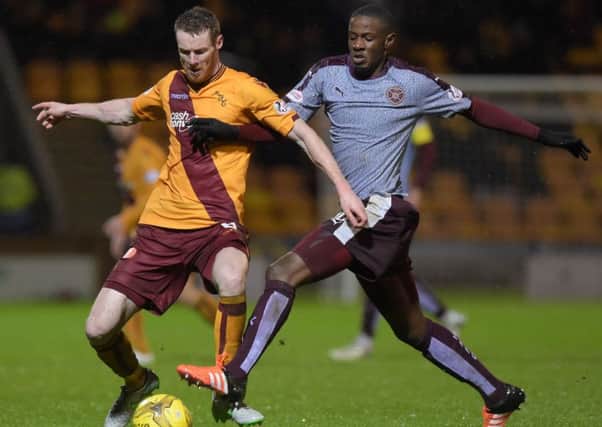 Hearts midfielder Arnaud Djoum, right, tussles with Stephen Pearson. Picture: SNS Group