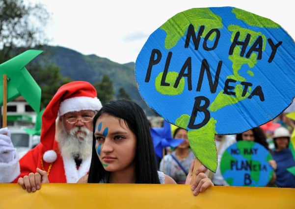 People take part in the Global Climate March in Bogota, Colombia on Sunday. Picture: AFP/Getty Images