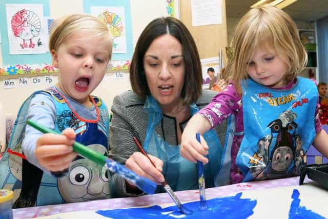 Scottish Labour leader Kezia Dugdale helps put the finishing touches to a Saltire flag painting. Picture: Gordon Fraser