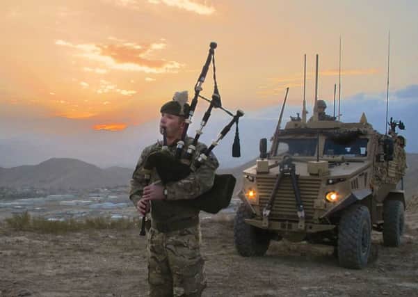 Corporal Kevin Glover from Palnackie, Dumfries and Galloway, piping to celebrate St Andrews Day outside Camp Qargha in Afghanistan. Picture: Contributed
