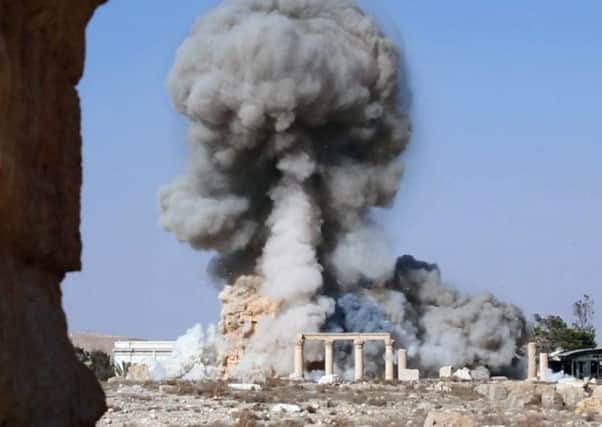 Smoke rising from the detonation of the 2,000-year-old temple of Baalshamin in Syria's ancient caravan city of Palmyra. Picture: AP