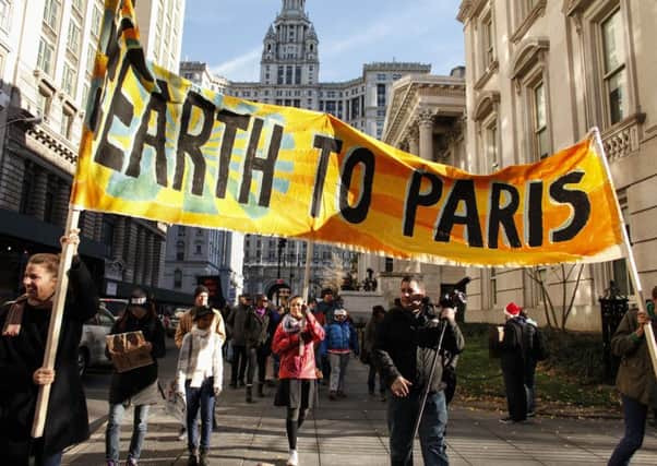 People hold a banner as they take part in a global climate march in New York. Picture: Getty Images