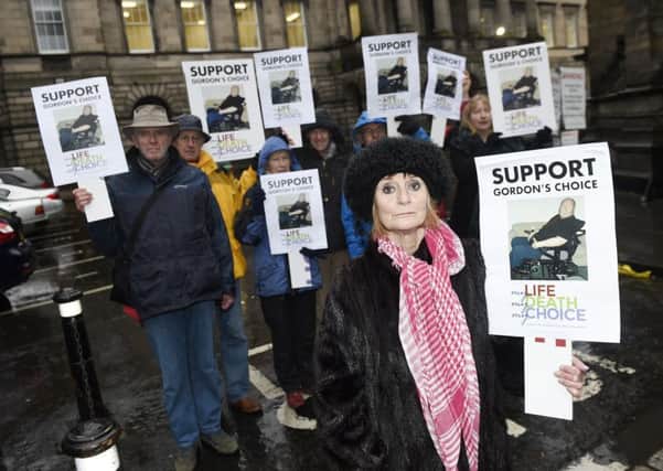 Sheila Duffy and other supporters make their point in Parliament Square before the court proceedings began yesterday. Picture: Greg Macvean