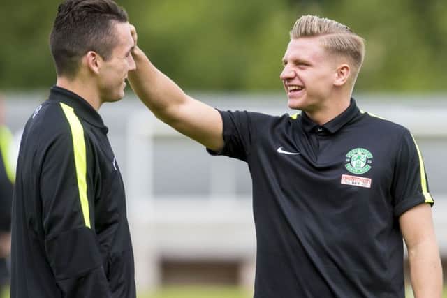 Jason Cummings, right, is a wanted man as he continues to bang in the goals for Hibs this season. Picture: SNS
