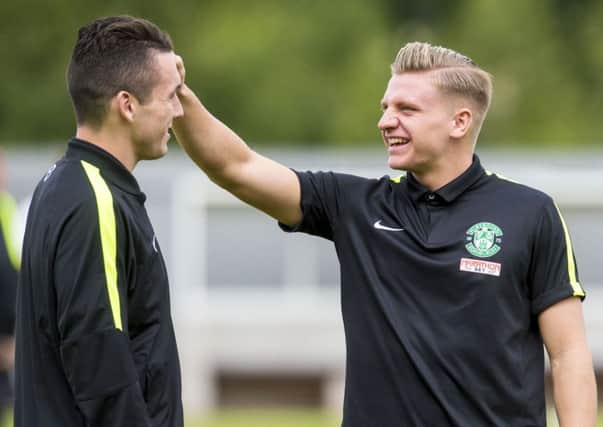 Jason Cummings, right, is a wanted man as he continues to bang in the goals for Hibs this season. Picture: SNS