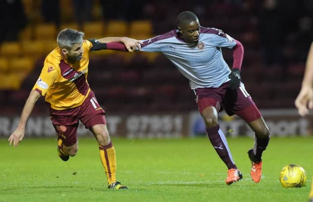 Hearts' Arnaud Djoum in action against Motherwell's Keith Lasley. Picture: SNS