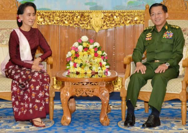 Aung San Suu Kyi meets outgoing leader and military commander-in-chief General Min Aung Hlaing. Picture: AFP/Getty Images