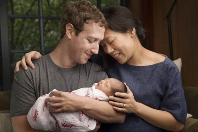 Max Chan Zuckerberg is held by her parents, Mark Zuckerberg and Priscilla Chan Zuckerberg. Picture: AP