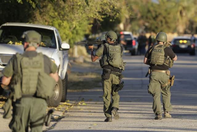 Law enforcement search for a suspect in a mass shooting at a Southern California social services centre. Picture: AP