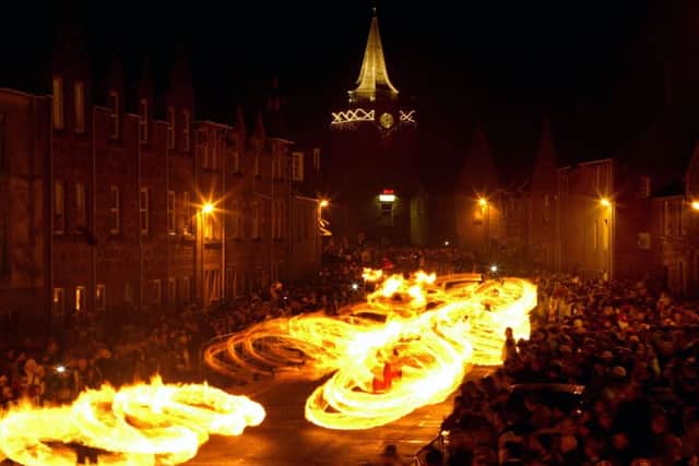 Hogmanay fireball swingers illuminate the streets of Stonehaven. Picture: Getty Images