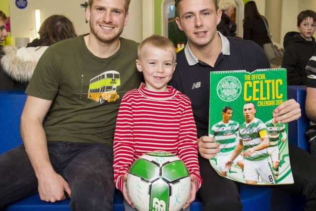 Scott Allan, right, and team-mate Stuart Armstrong visit Thomas Bennie as the Celtic squad handed over Christmas gifts at Glasgows Royal Hospital for Children. Picture: SNS