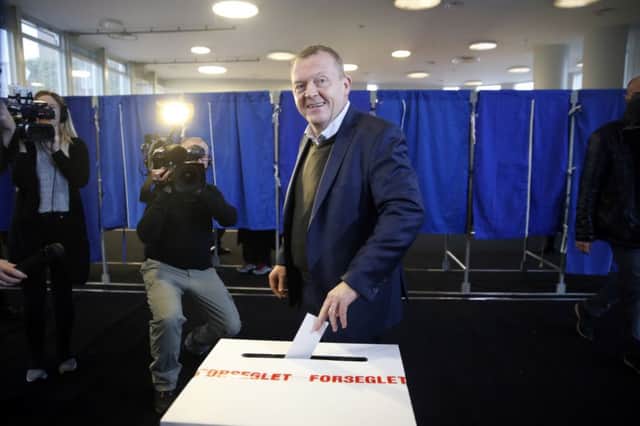 Danish Prime Minister Lars Loekke Rasmussen casts his vote yesterday. Picture: AP