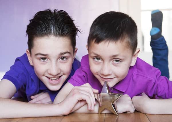 Left to right, Jack Thomson, 12, with his brother Louis Thomson, six. Picture: Cancer Research UK