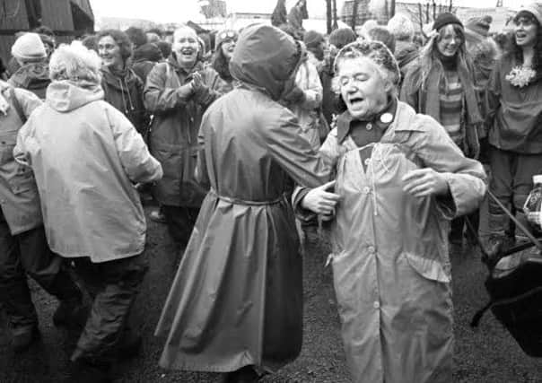 Women of all ages singing and dancing at the peace camp outside Faslane naval base in March 1983.
